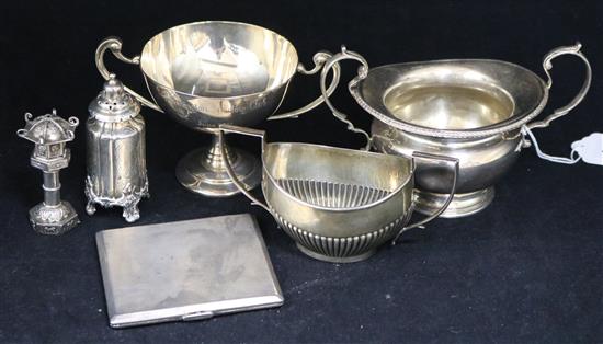 Two silver sugar bowls, a two handled trophy cup, two silver condiments and a cigarette case.